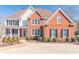 Charming two-story home featuring a mix of brick, neutral siding and well-maintained landscaping at 408 Hickory Fairway Ct, Woodstock, GA 30188