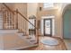 Grand foyer with wood floors, a wooden staircase and an elegant patterned front door at 408 Hickory Fairway Ct, Woodstock, GA 30188