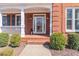 Inviting entryway featuring glass paned door with wreath, lantern, and manicured landscaping at 408 Hickory Fairway Ct, Woodstock, GA 30188