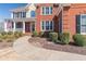 Beautiful two-story house with American flag, brick facade, trimmed shrubs, and lovely stone-lined sidewalk at 408 Hickory Fairway Ct, Woodstock, GA 30188