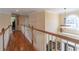 Bright hallway showcasing hardwood floors, elegant railing, and natural light from a large arched window at 408 Hickory Fairway Ct, Woodstock, GA 30188