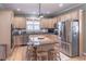 Kitchen featuring an island with seating, stainless steel appliances, and hardwood floors at 408 Hickory Fairway Ct, Woodstock, GA 30188