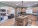 Open kitchen with island seating, stainless appliances, and views of the living area at 408 Hickory Fairway Ct, Woodstock, GA 30188