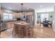 Eat-in kitchen featuring an island with seating, stainless steel appliances, and hardwood floors at 408 Hickory Fairway Ct, Woodstock, GA 30188