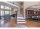 Open-concept living area and dining space showcases hardwood floors and large windows at 408 Hickory Fairway Ct, Woodstock, GA 30188