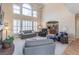 Bright, soaring living room with fireplace, and large windows offering an abundance of natural light at 408 Hickory Fairway Ct, Woodstock, GA 30188