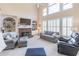 Spacious living room features a fireplace with built-in shelving and natural light at 408 Hickory Fairway Ct, Woodstock, GA 30188
