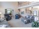 Open living room with staircase, large windows, hardwood floors, and comfortable seating at 408 Hickory Fairway Ct, Woodstock, GA 30188