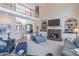 Bright living room features a fireplace, built-in shelves, and staircase to the second floor at 408 Hickory Fairway Ct, Woodstock, GA 30188