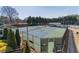 View of tennis courts in this community offering well-maintained landscaping at 408 Hickory Fairway Ct, Woodstock, GA 30188