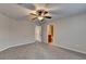 Bedroom featuring plush carpet, a ceiling fan, and an ensuite bathroom at 641 Freeman Brock Rd, Auburn, GA 30011