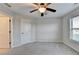 Bright bedroom featuring neutral paint, ceiling fan and adjacent bathroom access at 641 Freeman Brock Rd, Auburn, GA 30011