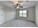 Spacious bedroom with carpet, ceiling fan, and a window providing natural light at 641 Freeman Brock Rd, Auburn, GA 30011