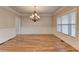 Classic dining room featuring a chandelier, wainscoting detail, and ample natural light, perfect for entertaining at 641 Freeman Brock Rd, Auburn, GA 30011
