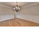 Open dining room featuring a chandelier, wainscoting detail, and offering a versatile space for meals at 641 Freeman Brock Rd, Auburn, GA 30011