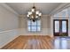 Dining room features a stunning chandelier, wood floors, and wainscoting at 641 Freeman Brock Rd, Auburn, GA 30011