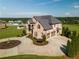 Aerial view of a large brick home with a circular driveway, basketball court and mature landscaping at 641 Freeman Brock Rd, Auburn, GA 30011