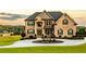 Stately brick home with manicured lawn, circular driveway, and fountain at 641 Freeman Brock Rd, Auburn, GA 30011