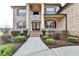Inviting front facade with stately columns, brick exterior, and beautifully landscaped entrance at 641 Freeman Brock Rd, Auburn, GA 30011