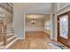 Welcoming home foyer showcasing a staircase, elegant chandelier, and a glimpse into the adjacent dining room at 641 Freeman Brock Rd, Auburn, GA 30011