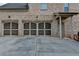 Exterior garage featuring three bays with brick walls and cement driveway at 641 Freeman Brock Rd, Auburn, GA 30011