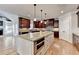 Spacious kitchen features an island with granite counters, stainless appliances, and hardwood flooring at 641 Freeman Brock Rd, Auburn, GA 30011