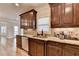Kitchen area features stained cabinets, granite countertop, and a stainless steel sink at 641 Freeman Brock Rd, Auburn, GA 30011
