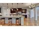 Kitchen with granite island features seating, stainless steel appliances, and dark wood cabinets at 641 Freeman Brock Rd, Auburn, GA 30011