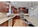 Gourmet kitchen with stainless steel appliances, granite countertops, and custom cabinetry at 641 Freeman Brock Rd, Auburn, GA 30011