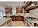 Well-equipped kitchen features custom cabinets, stainless steel appliances, granite countertops, and a hardwood floor at 641 Freeman Brock Rd, Auburn, GA 30011