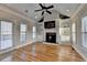 Bright living room with a fireplace, built-in shelving, and access to the outdoor space through a glass door at 641 Freeman Brock Rd, Auburn, GA 30011