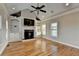 Comfortable living room featuring built-in shelving, a fireplace, and large windows providing natural light at 641 Freeman Brock Rd, Auburn, GA 30011