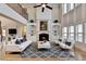 Bright living room with soaring ceilings, fireplace, custom bookshelves, and stylish furnishings at 641 Freeman Brock Rd, Auburn, GA 30011