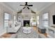 Cozy living room features a fireplace, modern decor, and ample natural light, creating an inviting space at 641 Freeman Brock Rd, Auburn, GA 30011