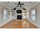 Inviting living room features built-in shelving, a fireplace, and a vaulted ceiling with fan for comfort at 641 Freeman Brock Rd, Auburn, GA 30011