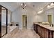 Relaxing main bathroom with dual vanities, a soaking tub, a separate shower, and elegant tile work at 641 Freeman Brock Rd, Auburn, GA 30011