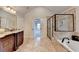 Elegant main bathroom featuring a separate shower, soaking tub, and dual vanities with granite countertops at 641 Freeman Brock Rd, Auburn, GA 30011
