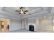 Main bedroom with tray ceiling, ceiling fan, and a cozy fireplace, creating a warm and inviting atmosphere at 641 Freeman Brock Rd, Auburn, GA 30011