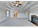 This main bedroom is bathed in light and features a tray ceiling with fan and elegant molding at 641 Freeman Brock Rd, Auburn, GA 30011