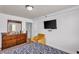 Cozy carpeted bedroom with dresser, TV, accent chair and view of neighborhood at 2479 Peachtree Ne Rd # 508, Atlanta, GA 30305