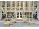 Welcoming building entrance with glass facade, flower planters, and meticulous landscaping at 2479 Peachtree Ne Rd # 508, Atlanta, GA 30305