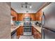 Efficient kitchen featuring stainless steel appliances, granite countertops, and wood cabinets at 2479 Peachtree Ne Rd # 508, Atlanta, GA 30305