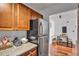 Galley kitchen with stainless steel refrigerator, granite counters, and eat-in dining space with wood floors at 2479 Peachtree Ne Rd # 508, Atlanta, GA 30305