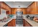 Efficient kitchen featuring granite countertops and stainless steel appliances, including a microwave and gas range at 2479 Peachtree Ne Rd # 508, Atlanta, GA 30305