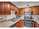 Well-maintained kitchen features granite countertops, stainless steel appliances, and warm wood cabinets at 2479 Peachtree Ne Rd # 508, Atlanta, GA 30305