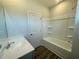 Well-lit bathroom showcasing a sink vanity and a bathtub with a shower at 2715 Stream Valley Lane Nw Nw Cir, Atlanta, GA 30318
