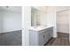 Well-lit bathroom showcasing a vanity with double sinks and a large mirror, next to a bedroom and a walk-in closet at 2715 Stream Valley Lane Nw Nw Cir, Atlanta, GA 30318