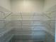 Spacious walk-in closet with multiple shelves for optimal storage and organization at 2715 Stream Valley Lane Nw Nw Cir, Atlanta, GA 30318