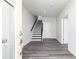 Open entryway featuring vinyl floors and a staircase with dark wood railing at 2715 Stream Valley Lane Nw Nw Cir, Atlanta, GA 30318