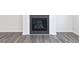 Close up view of a modern fireplace with gray wood flooring and white baseboards at 2715 Stream Valley Lane Nw Nw Cir, Atlanta, GA 30318